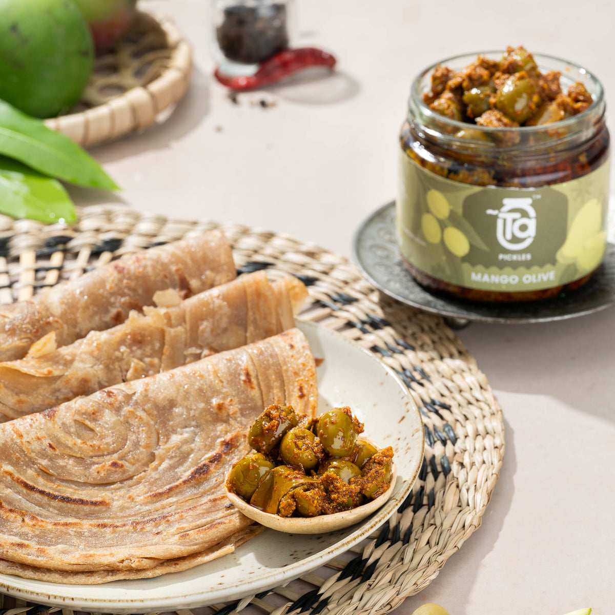 Ta Mango Olive Pickle served with layered parathas